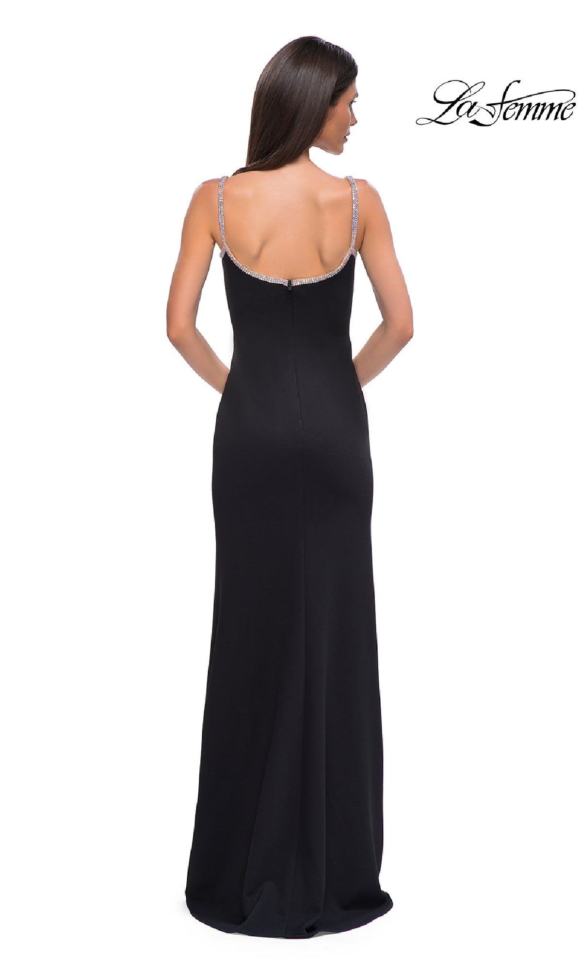 A woman with long brown hair is shown from the back wearing the Bead-Trimmed Long Prom Dress: La Femme 32844, featuring thin embellished straps and beaded trim. The